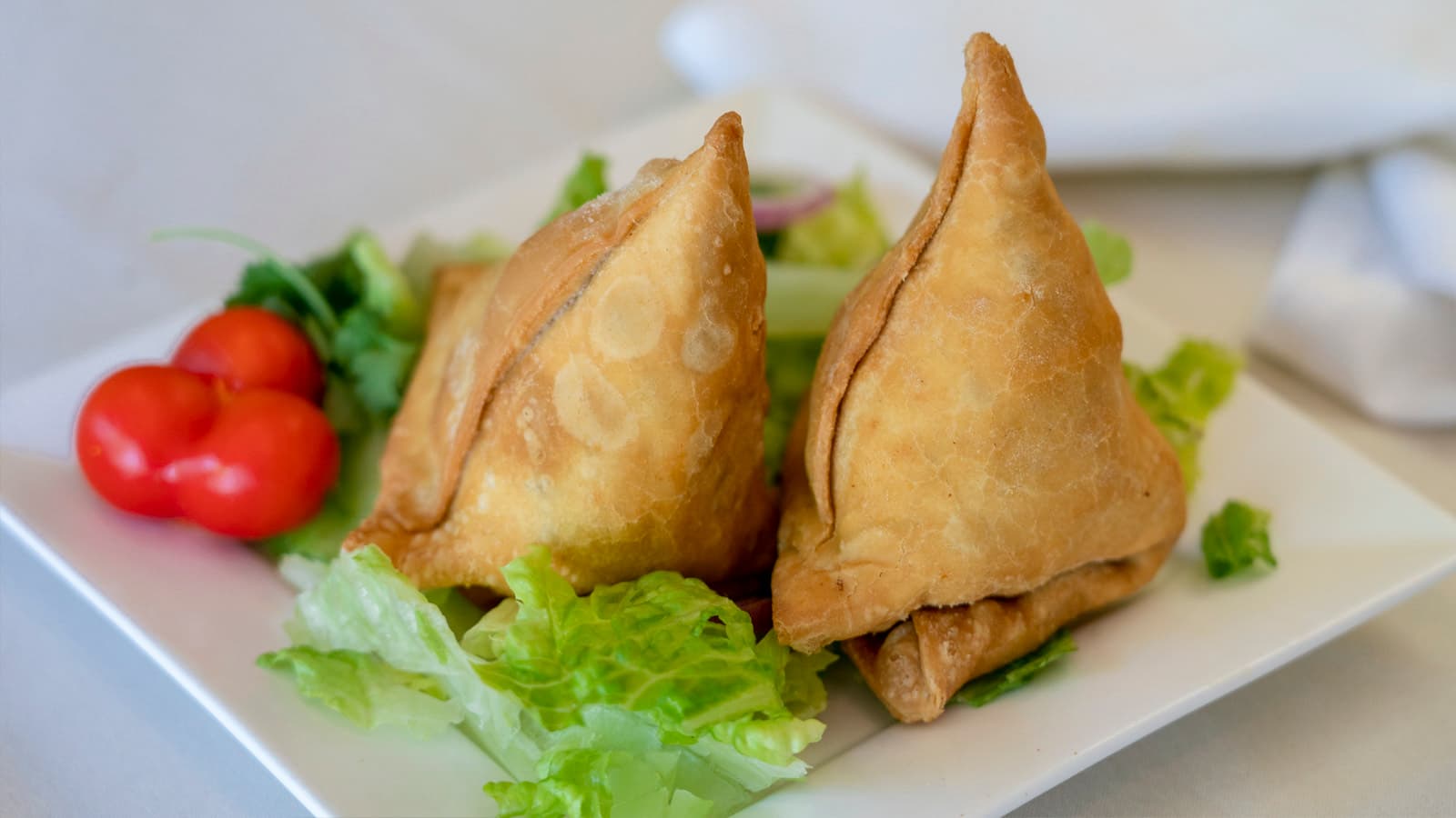 Vegetable samosas served with chutney